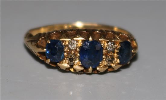 An Edwardian 18ct gold sapphire and diamond half hoop ring, size K.